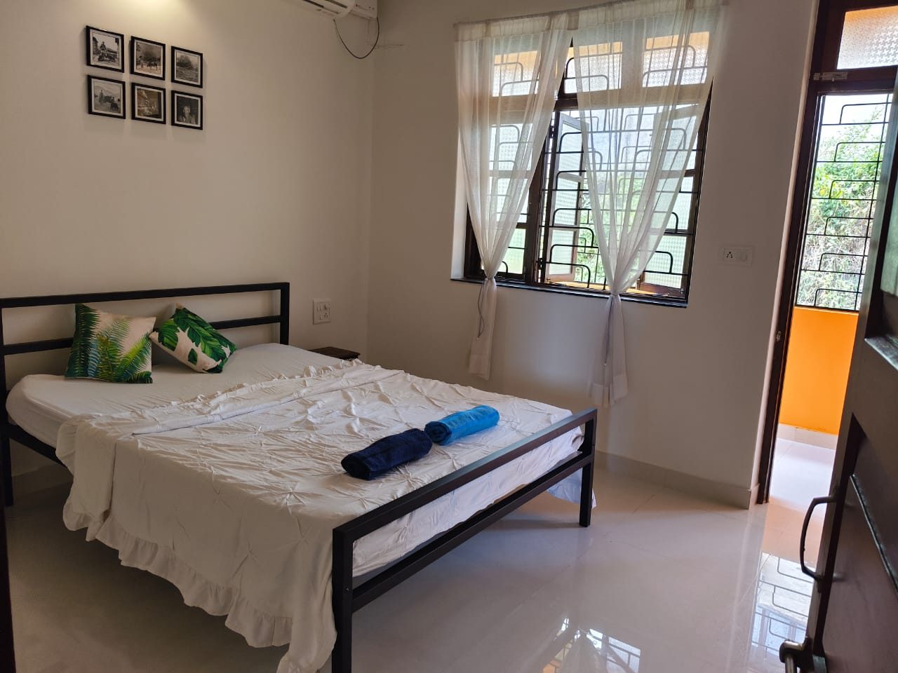 Top floor bedroom with a door open to the balcony